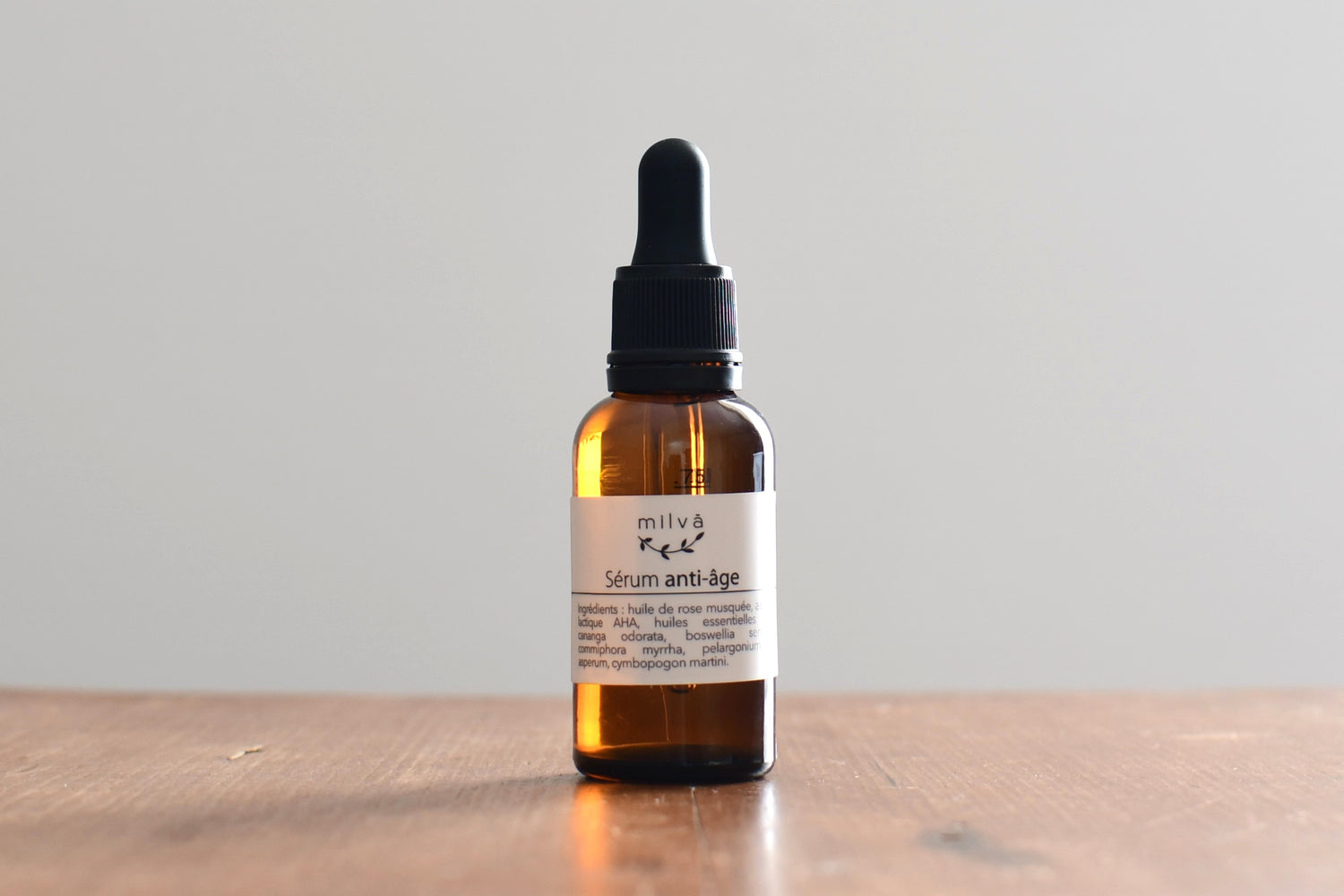 Serum anti-age dans un petit flacon en verre à l'aide d'une pipette